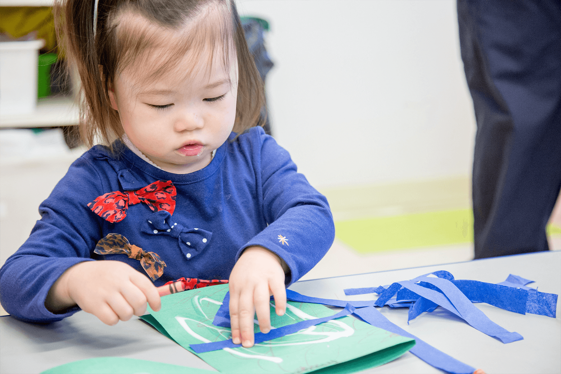 Child doing arts and crafts at day care